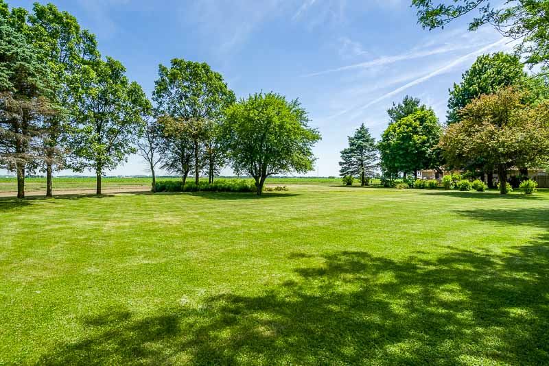 3644 Cutty Sark Road Cherry Valley, IL 61016 - Photo 27 of 33 a view of a big yard with a house in the background