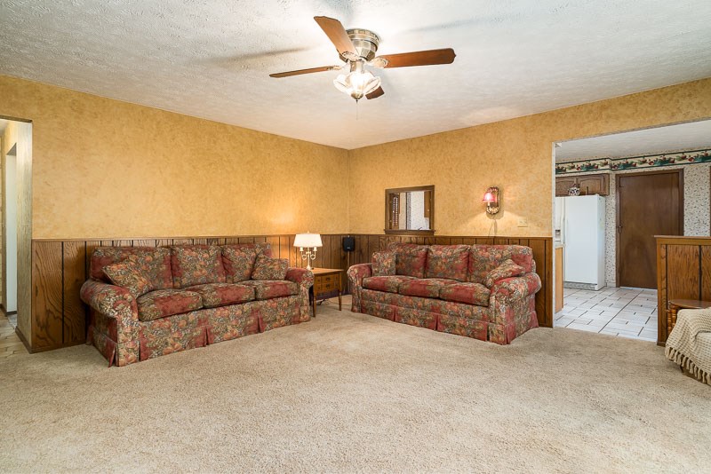 3644 Cutty Sark Road Cherry Valley, IL 61016 - Photo 7 of 33 a living room with a couch and a ceiling fan