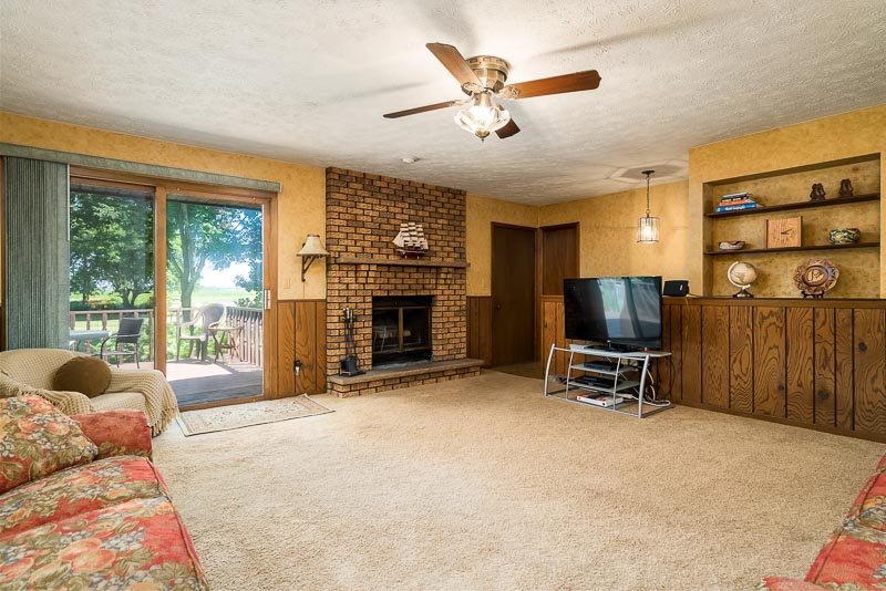 3644 Cutty Sark Road Cherry Valley, IL 61016 - Photo 9 of 33 a living room with furniture a flat screen tv and a fireplace