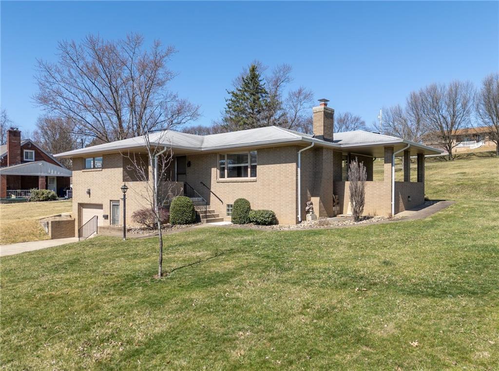 12217 Longview Drive Irwin, PA 15642 - Photo 3 of 36 a view of a white house with a big yard and large tree