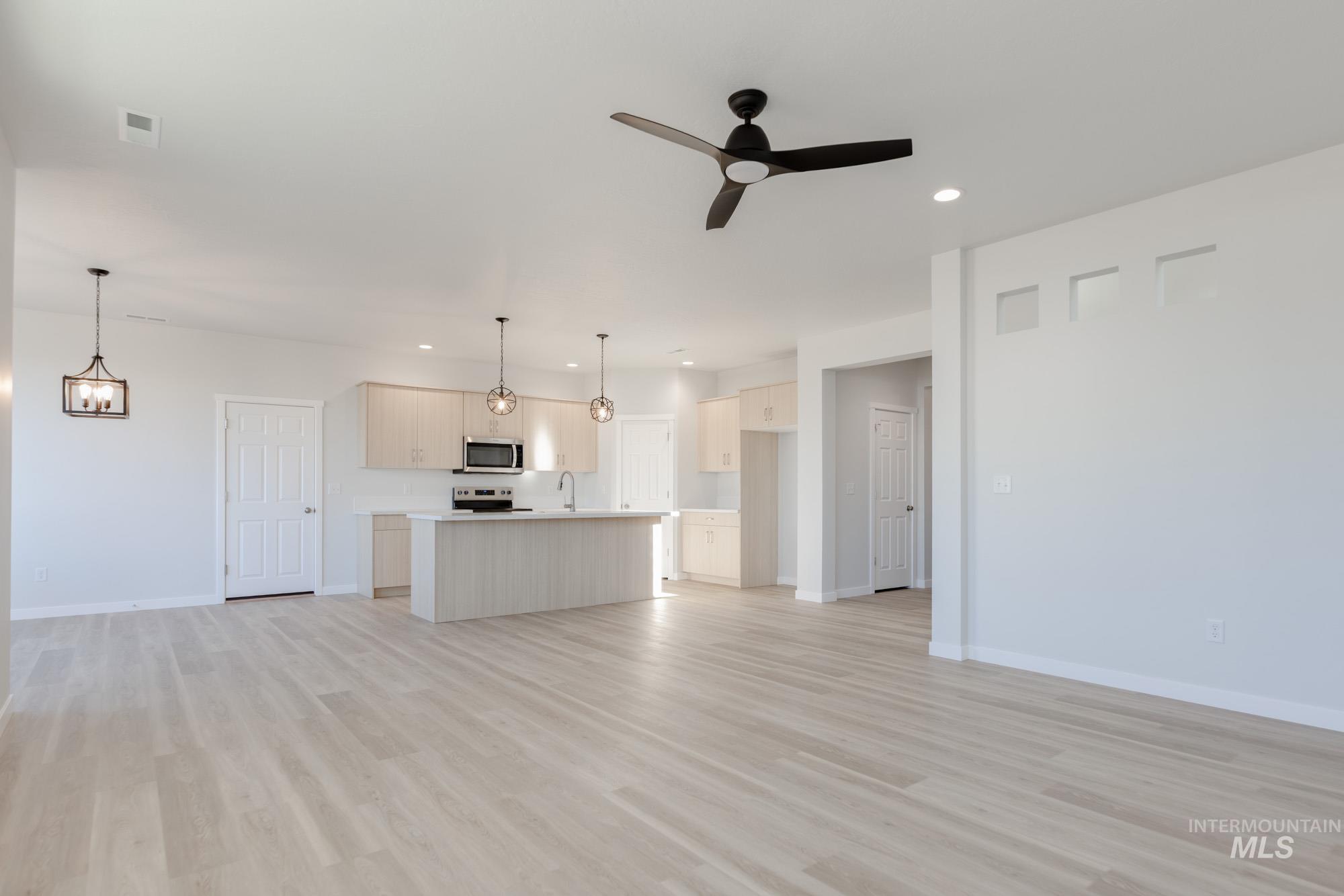1639 Celina Street Middleton, ID 83644 - Photo 7 of 19 Open-concept living area with light wood-finish flooring