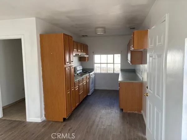 a kitchen with sink cabinets and wooden floor