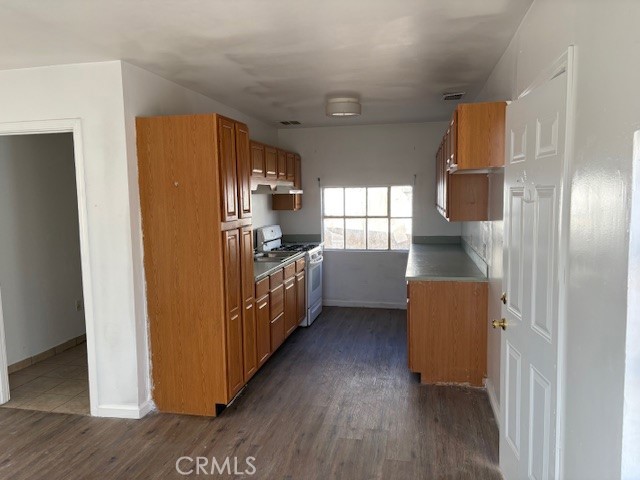 451 West Yermo Road Yermo, CA 92398 - Photo 15 of 23 a kitchen with sink cabinets and wooden floor