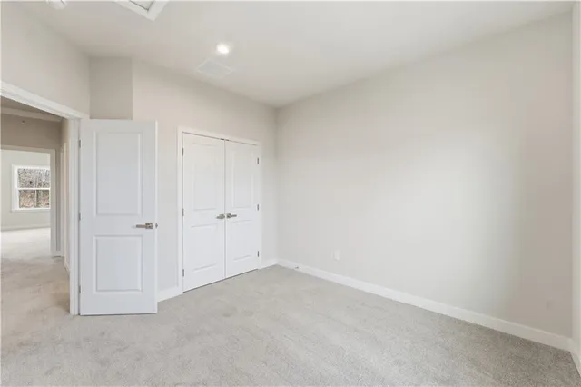 a bathroom with a bathtub shower sink vanity mirror and toilet