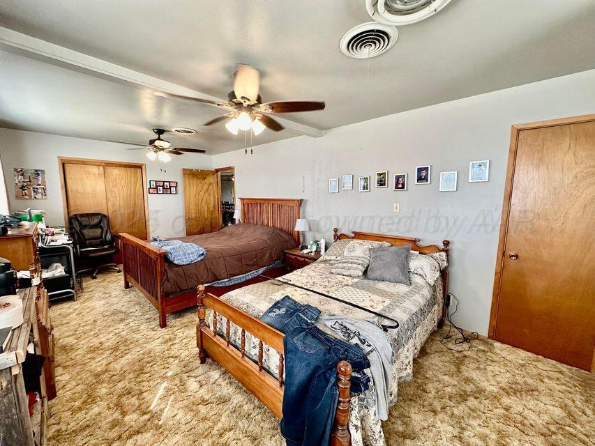 15200 Highway 152 Wheeler, TX 79096 - Photo 12 of 71 a bed room with two bed and a ceiling fan