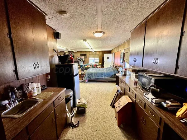 a view of a chair and table in backyard of potted plants