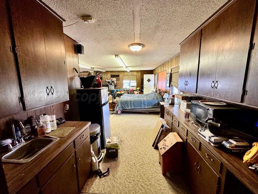 15200 Highway 152 Wheeler, TX 79096 - Photo 18 of 71 a kitchen with a sink appliances and cabinets