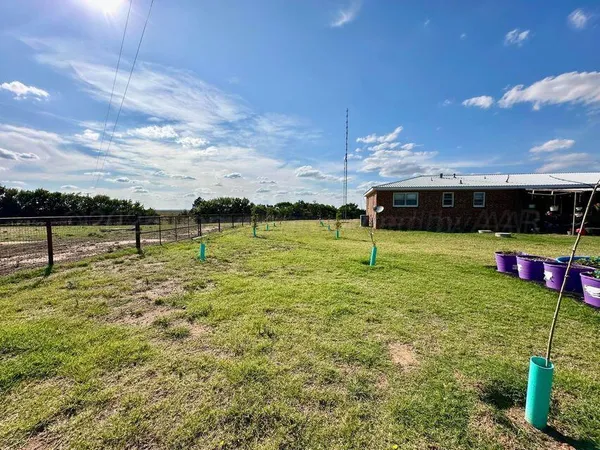a view of a lake with lawn chairs