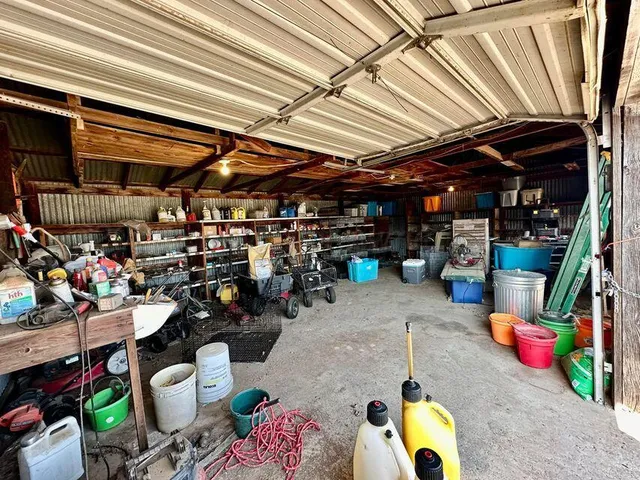 a view of a dry yard with wooden fence