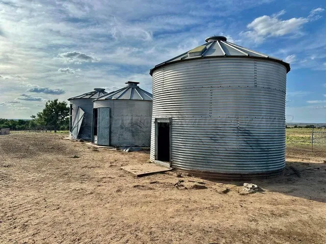 a view of a lake with a big yard and large trees