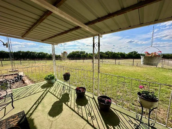 a kitchen with stainless steel appliances kitchen island granite countertop a refrigerator a stove and a sink with wooden floor