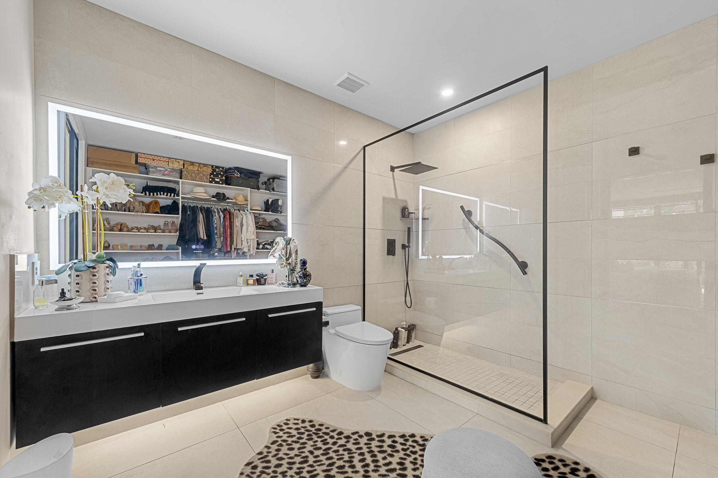 7819 Lakeside Boulevard, Unit 814 Boca Raton, FL 33434 - Photo 14 of 37 a bathroom with a double vanity sink toilet mirror and shower