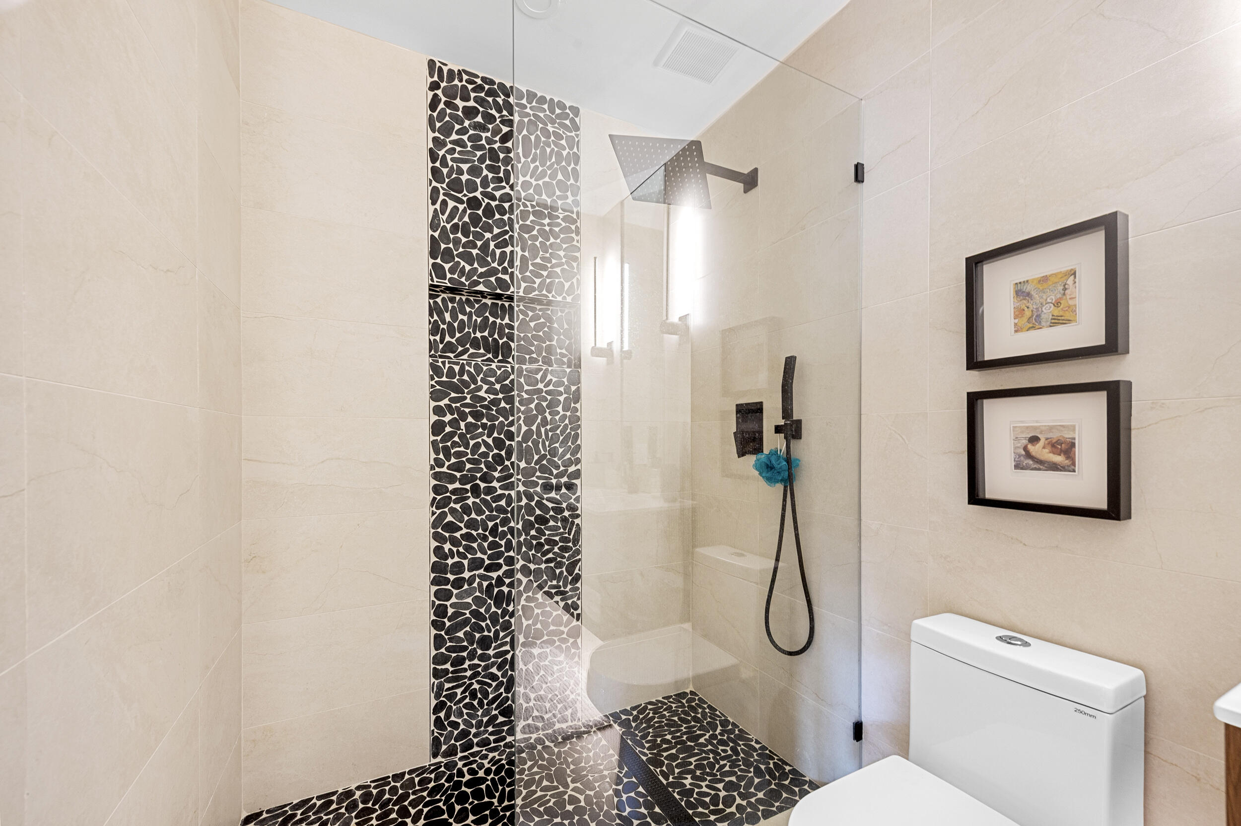 7819 Lakeside Boulevard, Unit 814 Boca Raton, FL 33434 - Photo 17 of 37 a bathroom with a toilet a sink and a shower