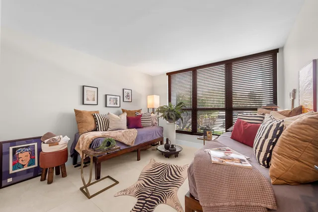 a bedroom with furniture and a large window