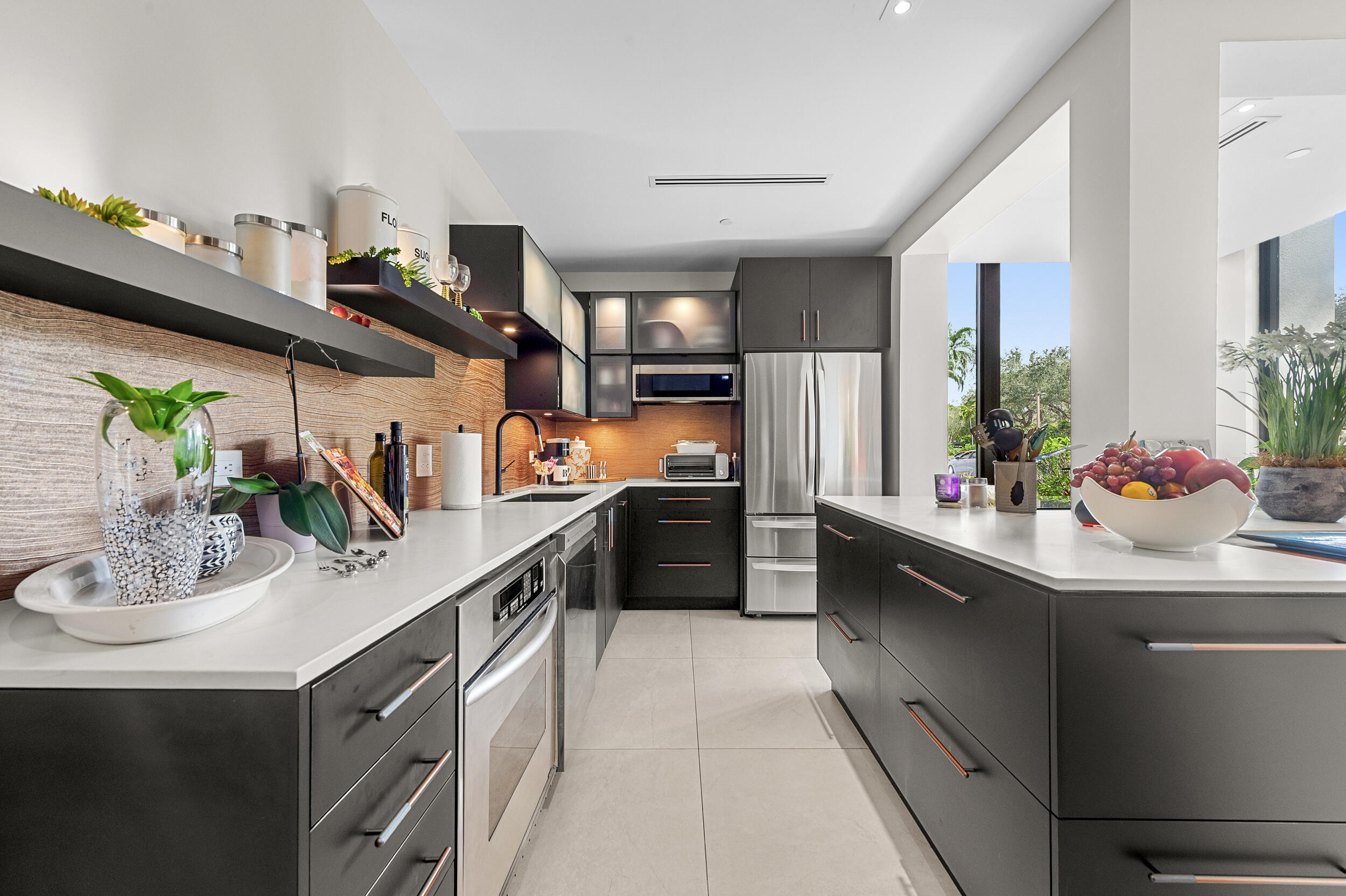 7819 Lakeside Boulevard, Unit 814 Boca Raton, FL 33434 - Photo 2 of 37 a kitchen with stainless steel appliances granite countertop a sink and stove