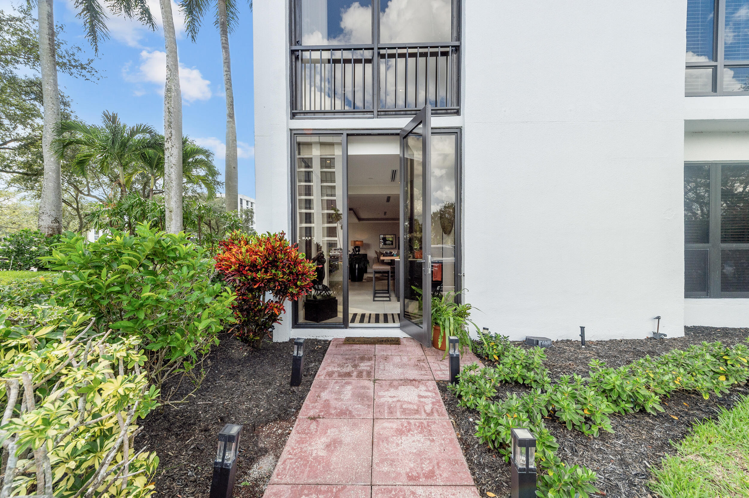 7819 Lakeside Boulevard, Unit 814 Boca Raton, FL 33434 - Photo 25 of 37 front view of a house with a yard