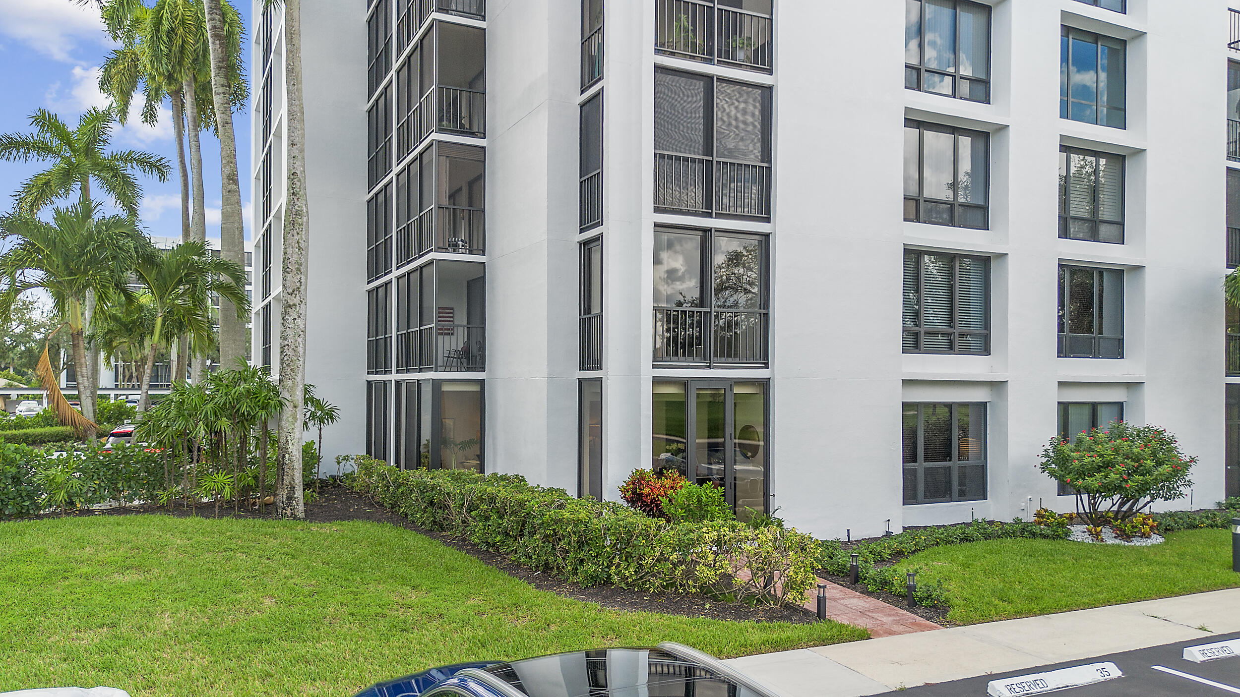 7819 Lakeside Boulevard, Unit 814 Boca Raton, FL 33434 - Photo 27 of 37 a view of backyard with potted plants and floor to ceiling window