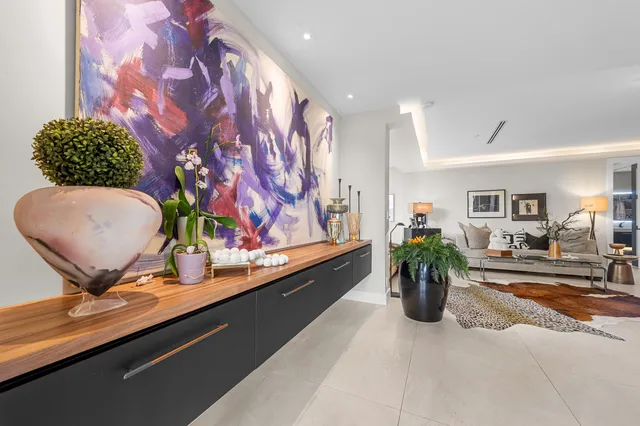 a dining room with furniture and potted plant