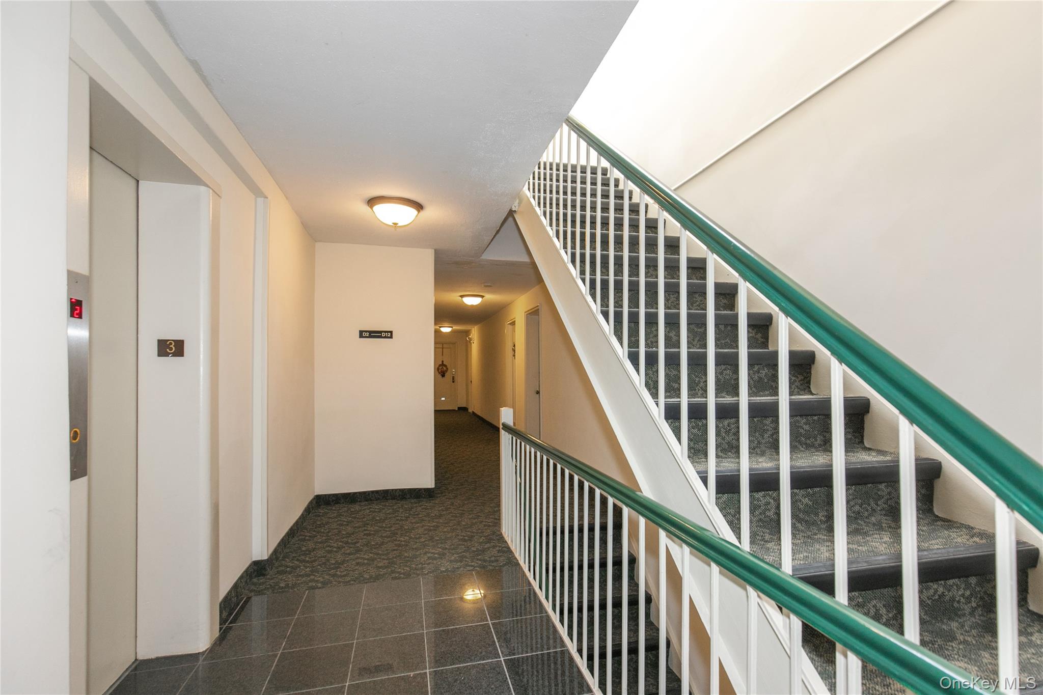 15 Canterbury Road, Unit D6 Great Neck, NY 11021 - Photo 13 of 21 a view of staircase with wooden floor and stairs