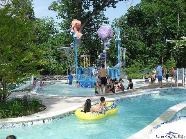 15 Canterbury Road, Unit D6 Great Neck, NY 11021 - Photo 20 of 21 a front view of a house with a garden and patio