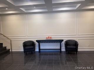 15 Canterbury Road, Unit D6 Great Neck, NY 11021 - Photo 4 of 21 a living room with furniture and a chair