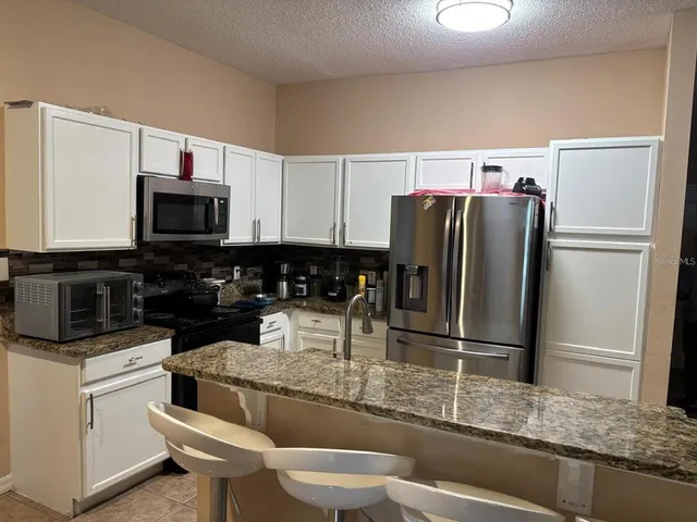 a kitchen with a refrigerator and a sink