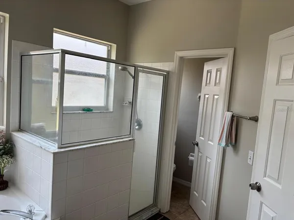 a bathroom with a glass shower door and a sink