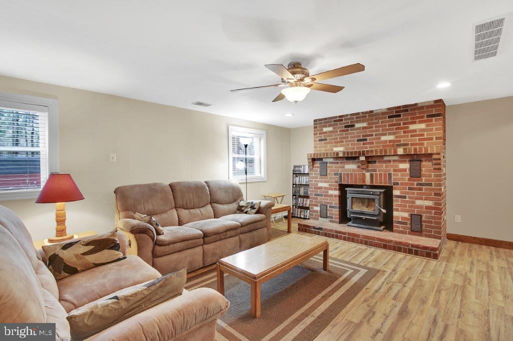 1159 Old Elk Neck Road Elkton, MD 21921 - Photo 5 of 32 Inviting Bricked Fireplace with Wood Stove Insert