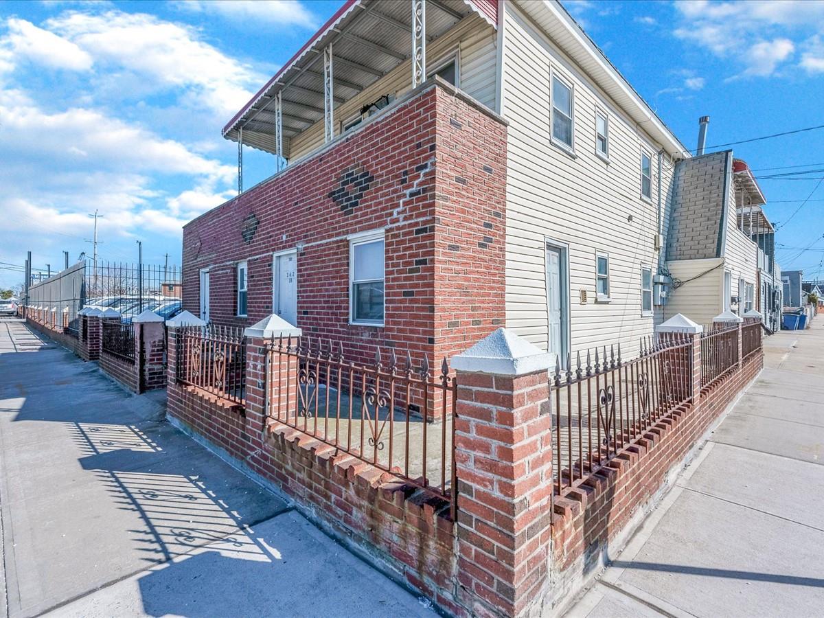 362 Beach 88th Street Queens, NY 11693 - Photo 3 of 16 a view of a brick house with wooden fence