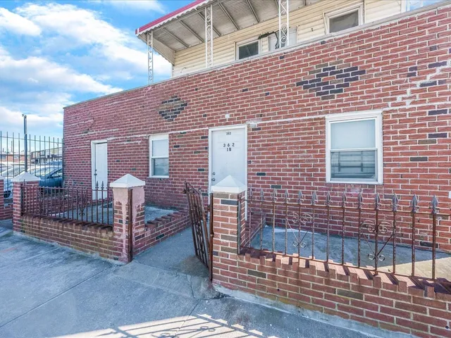 a view of a brick house with many windows