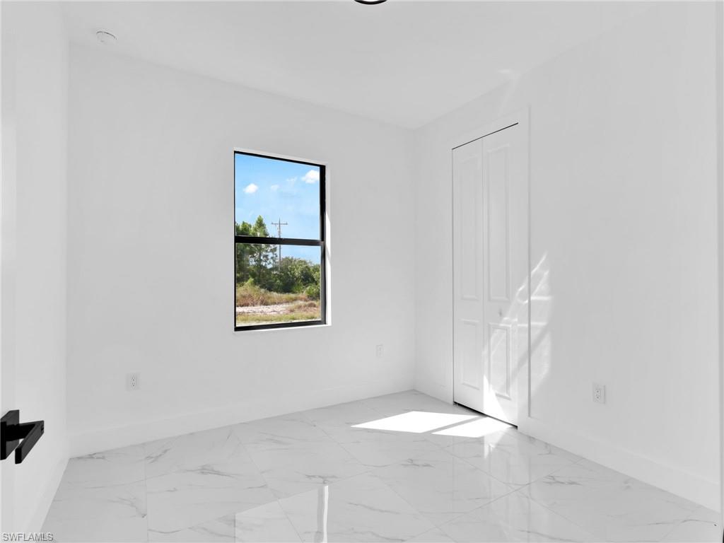 3417 8th Street Southwest Lehigh Acres, FL 33976 - Photo 15 of 32 a view of an empty room with a window