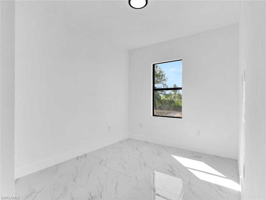 3417 8th Street Southwest Lehigh Acres, FL 33976 - Photo 18 of 32 an empty room with a window