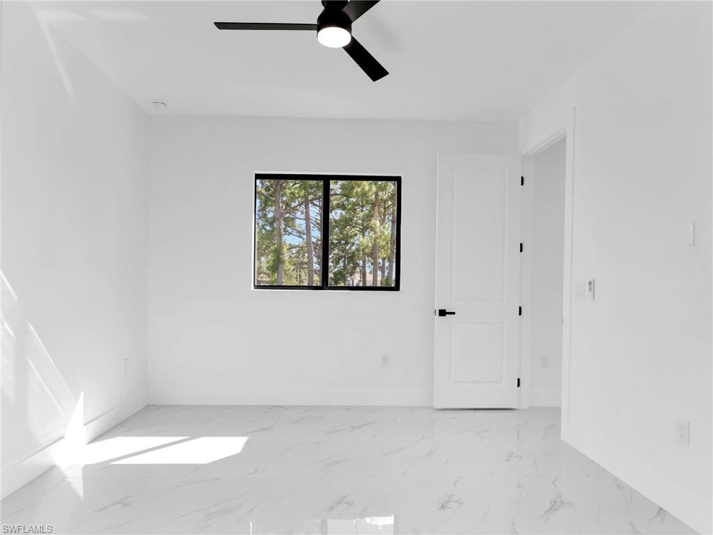 3417 8th Street Southwest Lehigh Acres, FL 33976 - Photo 21 of 32 a view of an empty room with a window