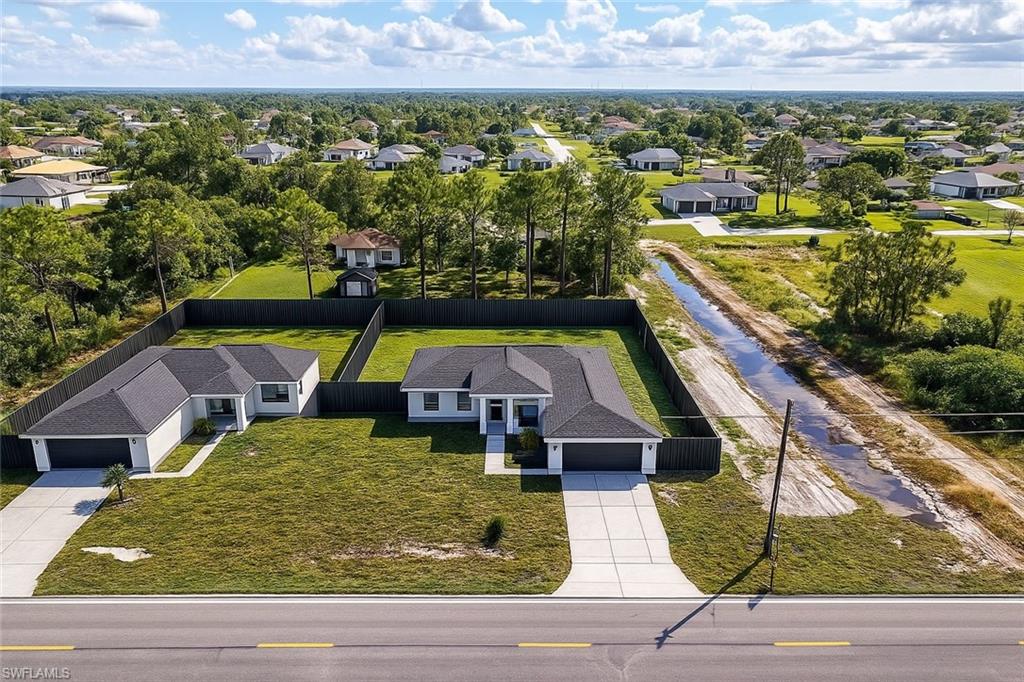 3417 8th Street Southwest Lehigh Acres, FL 33976 - Photo 29 of 32 an aerial view of residential houses with outdoor space