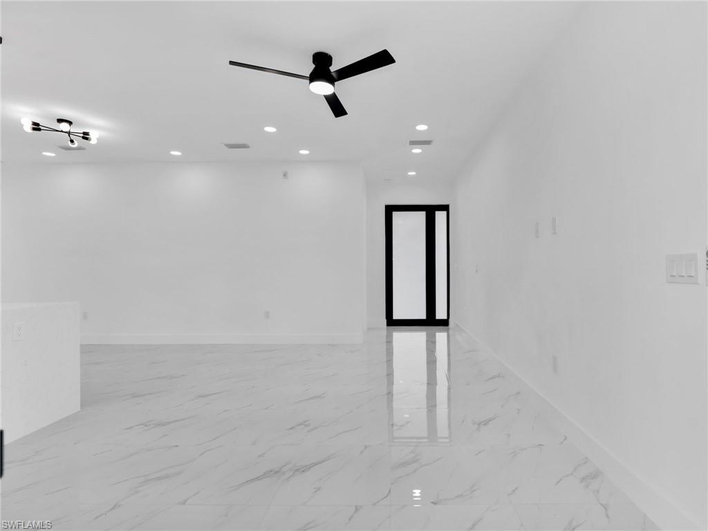 3417 8th Street Southwest Lehigh Acres, FL 33976 - Photo 6 of 32 wooden floor in an empty room with a window