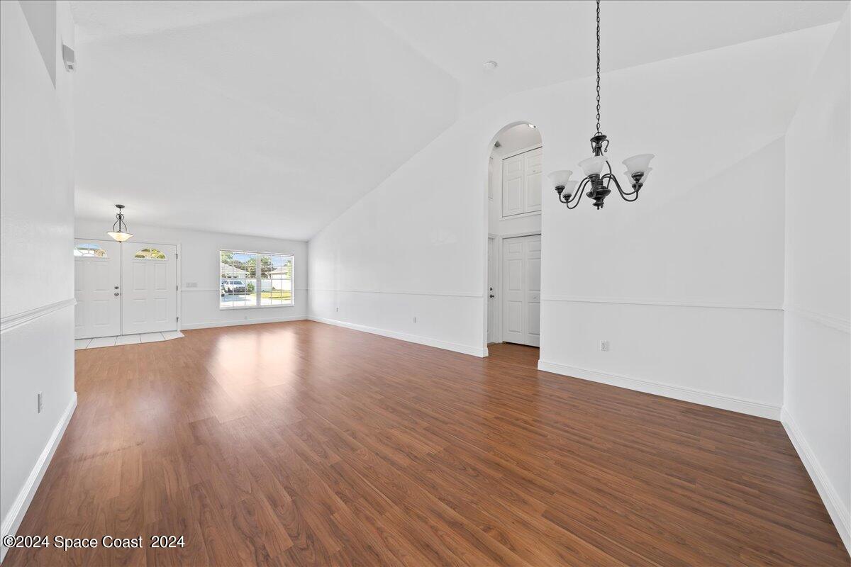 432 Stonehenge Circle Rockledge, FL 32955 - Photo 11 of 41 a view of an empty room with wooden floor and a window