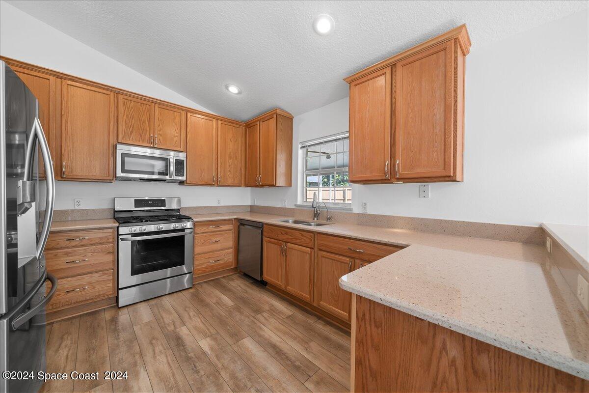 432 Stonehenge Circle Rockledge, FL 32955 - Photo 13 of 41 a kitchen with granite countertop wooden cabinets and a stove top oven