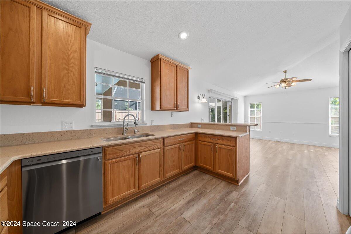432 Stonehenge Circle Rockledge, FL 32955 - Photo 14 of 41 a kitchen with granite countertop a sink cabinets and wooden floor