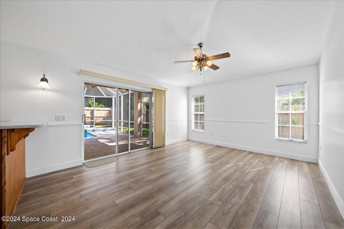 432 Stonehenge Circle Rockledge, FL 32955 - Photo 17 of 41 a view of an empty room with a window and wooden floor