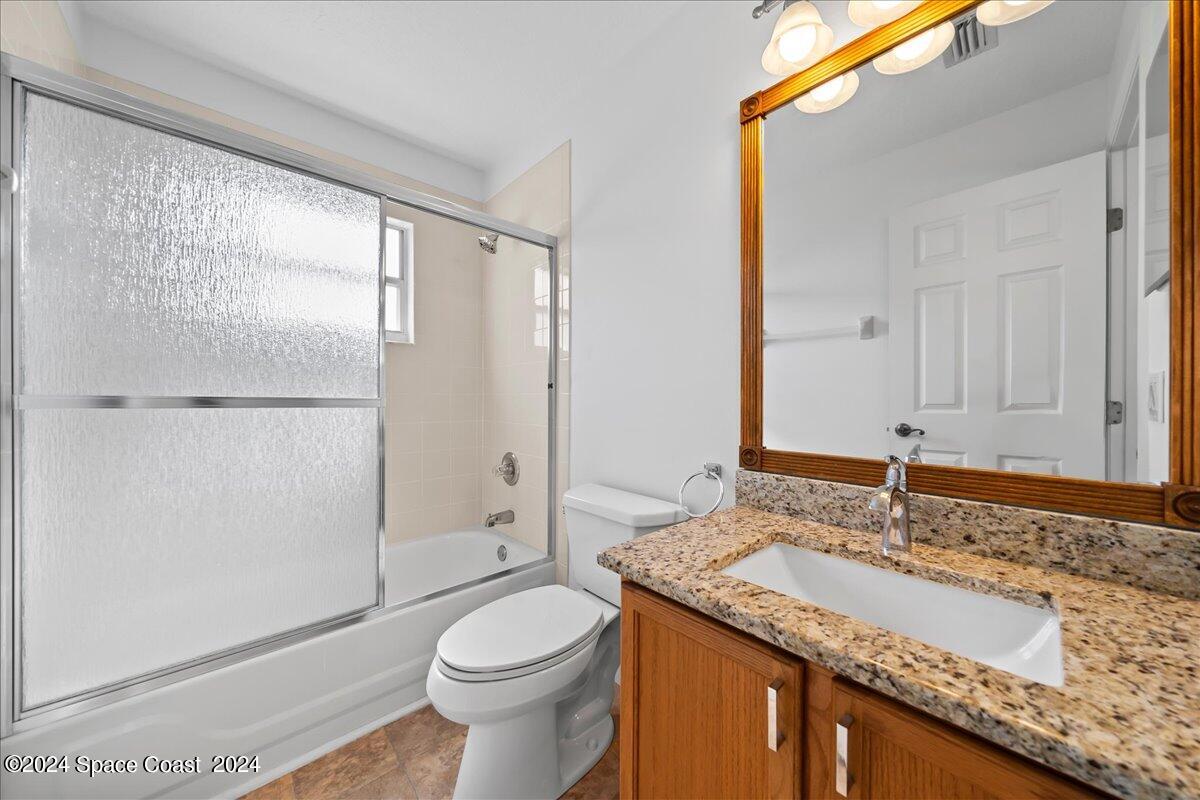 432 Stonehenge Circle Rockledge, FL 32955 - Photo 27 of 41 a bathroom with a granite countertop sink toilet and shower