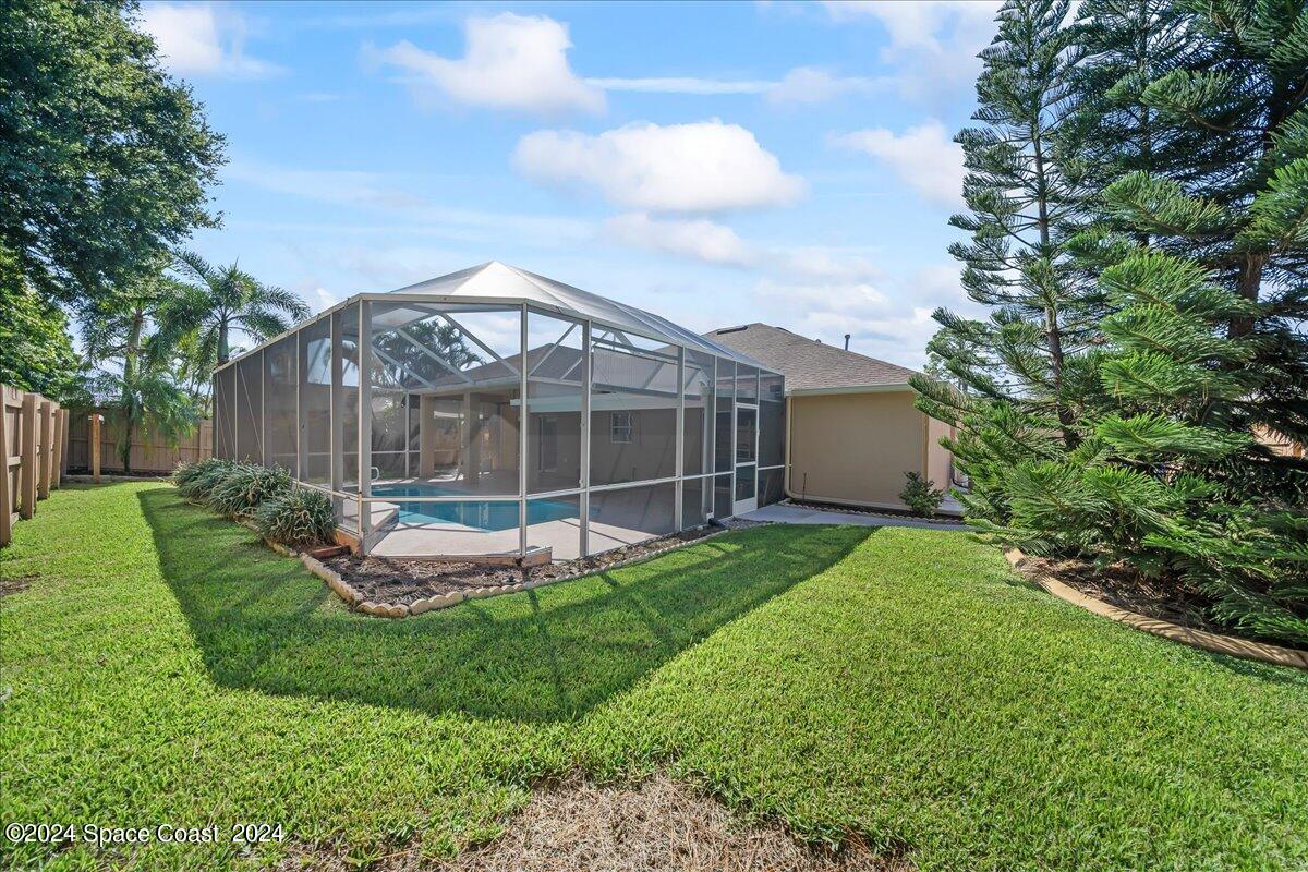 432 Stonehenge Circle Rockledge, FL 32955 - Photo 29 of 41 a view of a house with backyard sitting area and garden