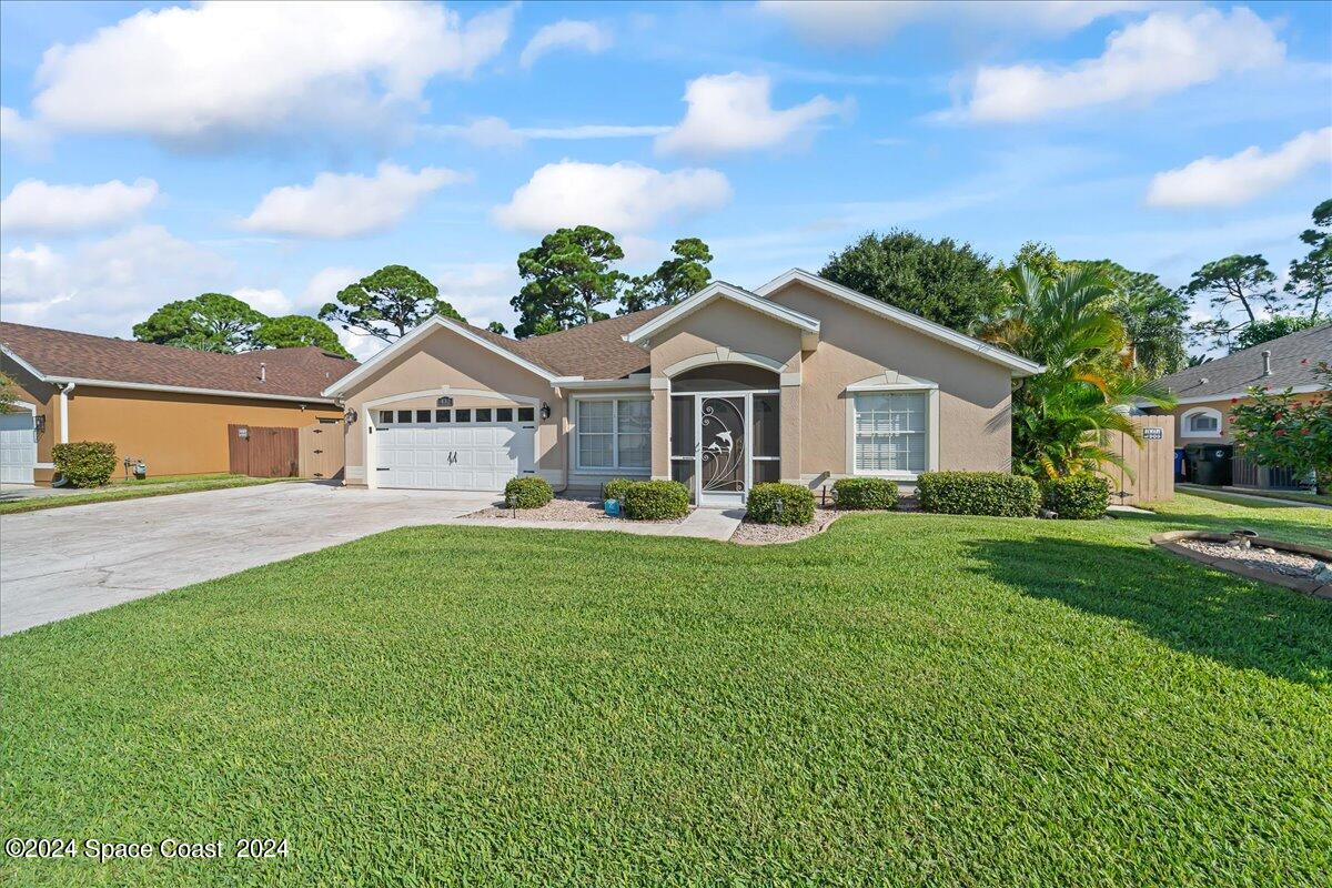 432 Stonehenge Circle Rockledge, FL 32955 - Photo 31 of 41 a front view of a house with a garden