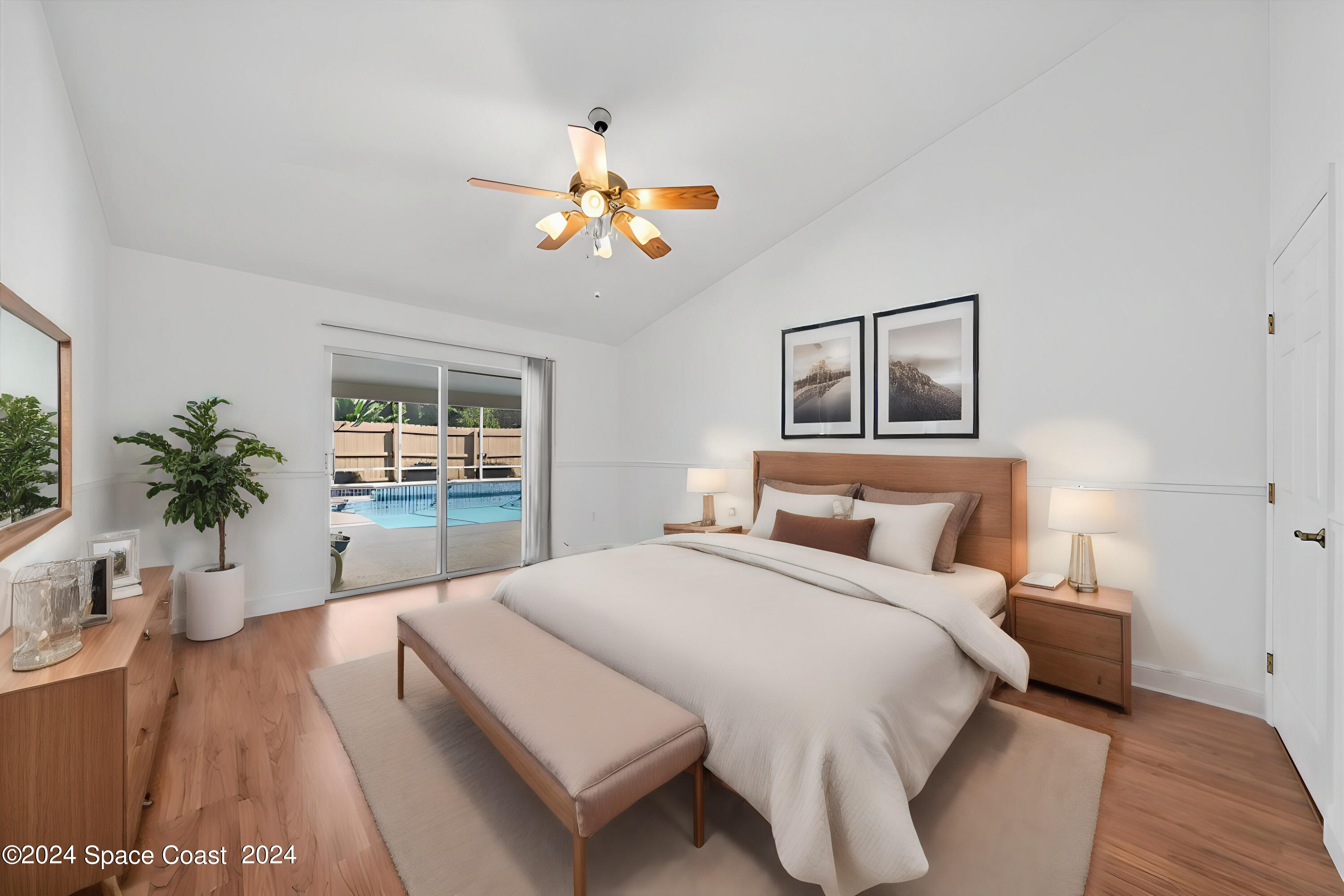 432 Stonehenge Circle Rockledge, FL 32955 - Photo 6 of 41 a bedroom with a large bed and a chandelier