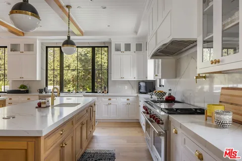 a living room with furniture a window and kitchen view