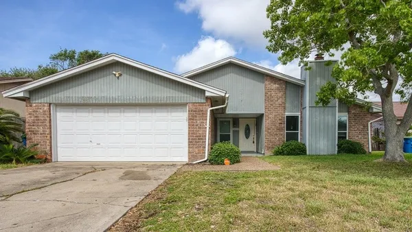a front view of house with garage and yard