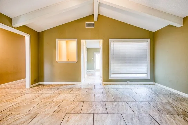 a view of a big room with windows and chandelier