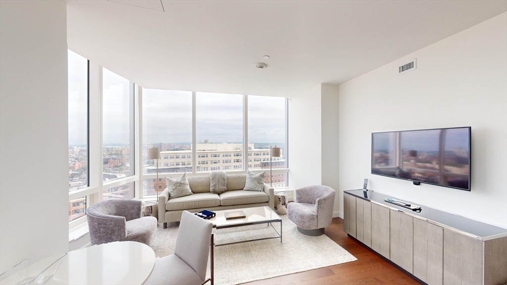 40 Trinity Place, Unit 1605 Boston, MA 02116 - Photo 2 of 16 a living room with furniture and a flat screen tv