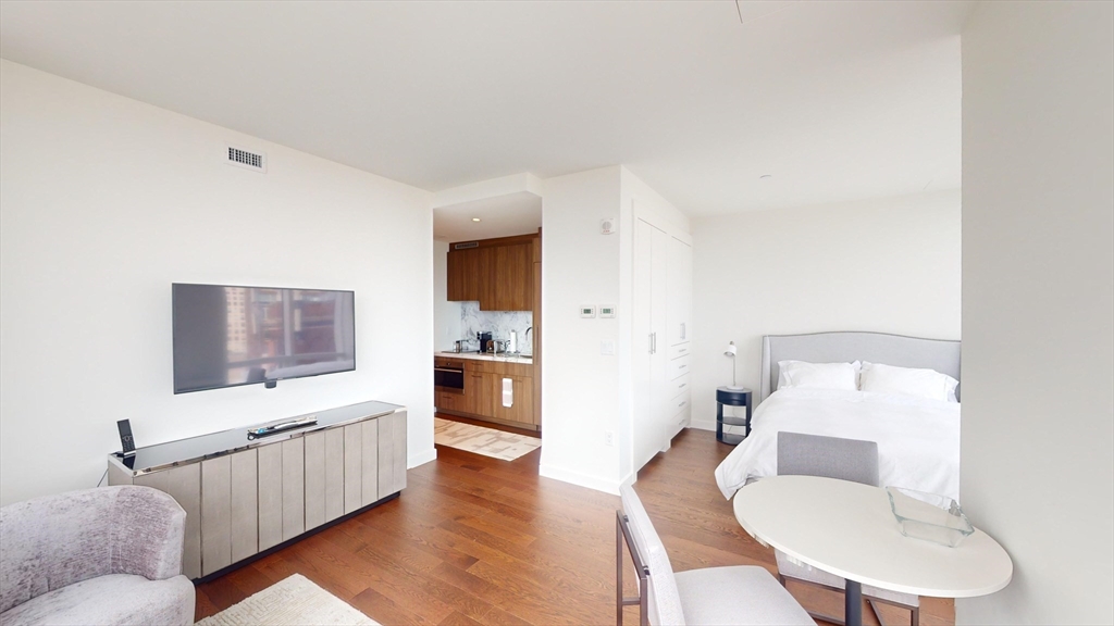 40 Trinity Place, Unit 1605 Boston, MA 02116 - Photo 3 of 16 a living room with furniture and a flat screen tv