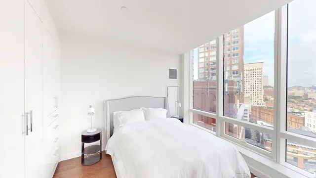 a bedroom with a bed and a large window