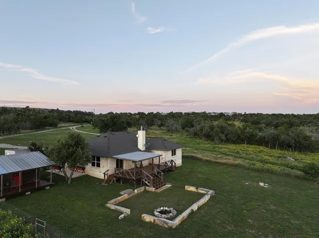 an aerial view of a house with pool garden view and a lake view